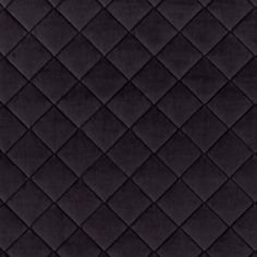 an up close view of a black quilted fabric with diamond design on the edges