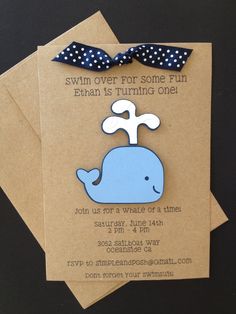 two brown envelopes with blue and white whale magnets on them, one has a polka dot bow