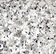 a white and black speckled surface with small dots