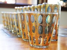 several glasses are lined up on a table