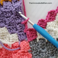 the crochet is laying on top of each other with a blue handled crochet hook