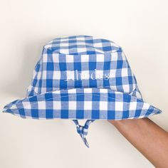 embodied gingham blue and white hat. embroidered text is in white Baby Sun Hat, A Day At The Beach, Day At The Beach, Blue Baby, Gingham Print, Cornflower Blue, Sun Hat, Sun Hats, At The Beach