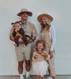 a man, woman and child are dressed up in animal costumes while standing next to each other