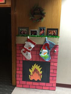 a fireplace decorated for christmas with stockings and hats