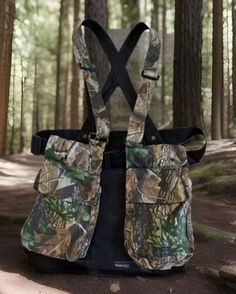 the back view of a camouflaged backpack in the woods