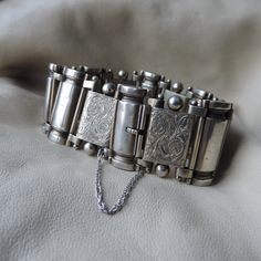 antique sterling panel bracelet - etched sterling silver thick antique bracelet - unisex 925 hand etched flora bracelet - thick chain link sterling bracelet - amazing piece  of history - true 18th century sterling silver perfect weight wide panel bracelet - hand crafted large alternating types of hollow panels - hinges at either side with small ball top details - larger rectangular panels have a hand etched flora paisley design with a large sphere at the top - smooth taller thinner column panels Collectible Sterling Silver Antique Bracelet, Heirloom Silver Engraved Bracelets, Vintage Engraved White Gold Bracelets, Antique Engraved Sterling Silver Bracelet For Formal Events, Heirloom Style Silver Metal Bracelets, Victorian Hallmarked Silver Bracelets, Victorian Silver Hallmarked Bracelet, Victorian Hallmarked Silver Bracelet, Antique Silver Bracelet With Intricate Design