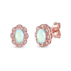 Complement your elegant style with the vintage-inspired and art deco details of these oval opal and diamond scallop frame stud earrings. Fashioned in precious 10K rose gold Each earring shines with a 6.0 x 4.0mm oval-shaped iridescent opal cabochon. A scalloped frame of diamond-adorned marquise shapes surrounds the center. Intricate milgrain borders add heirloom appeal. These 1/20 ct. t.w. diamond post earrings secure comfortably with friction backs. Scalloped Frame, Gold Book, Peoples Jewellers, Frame Art, Opal Jewelry, Earring Backs, Designer Earrings, Elegant Style, Post Earrings