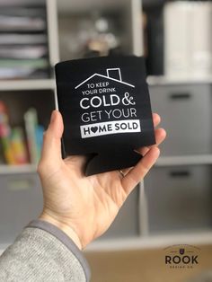 a person holding up a black box with the words cold and get your home sold