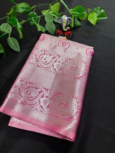 This exquisite Semi Kanchipuram Saree is a stunning addition to any wardrobe. The premium quality soft material is comfortable against the skin and drapes beautifully, making it perfect for special occasions. The vibrant pink color adds a pop of brightness to the traditional design, while the intricate gold border detailing adds a touch of elegance. Made with care and attention to detail, this saree is a must-have for any fashion-forward individual looking to make a statement at a wedding, party, or cultural event.Upgrade your saree collection with this timeless piece that effortlessly combines classic style with modern sophistication. Pink Tissue Silk Saree For Eid, Elegant Pink Tissue Silk Traditional Wear, Pink Tissue Silk Traditional Wear With Pallu, Pink Tissue Silk Saree For Festivals, Pink Tissue Silk Saree For Celebration, Elegant Pink Art Silk Traditional Wear, Pink Tissue Silk Saree With Self Design, Traditional Drape Blouse Piece In Pink For Celebrations, Pink Saree For Celebration With Traditional Drape