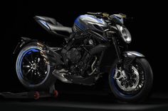 a black and blue motorcycle parked in the dark