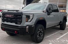 a gray truck parked in front of a building