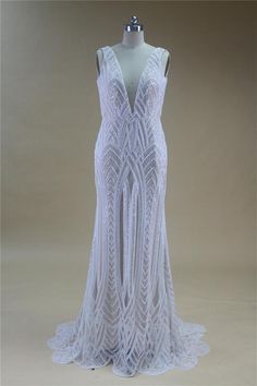 a white dress on a mannequin with an open back and crochet detailing