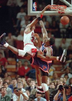 two basketball players in the air during a game