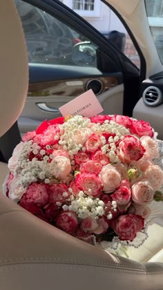 a bouquet of flowers sitting in the back seat of a car