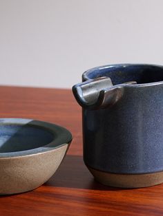 two bowls sitting on top of a wooden table