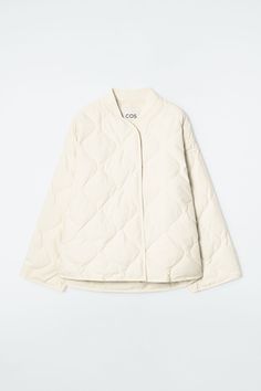 Designed for the cooler months ahead, this modern jacket is filled with a recycled down and feather padding that's diamond-quilted for even heat distribution. It's cut in an oversized shape and has a ribbed collar, a number of pockets and a stepped hem at the back. The crisp off-white hue will style effortlessly with the rest of your wardrobe.  Oversized fitSnap-stud closure, internal patch pocketA better alternative to conventional polyester, recycled polyester is made from pre‐ and post‐consumer waste Shell & Lining: 100% Recycled polyester, Padding: 80% Recycled down, 20% Recycled feather / Machine wash Back length of size S is 26.97" / Model wears a size S Cream Quilted Jacket, Quilt Jacket, Tailored Design, White Quilt, Dark Khaki, Diamond Quilt, Women's Coats & Jackets, Winter Casual, Padded Jacket