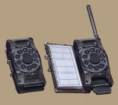 two old fashioned phones with a notepad attached to them