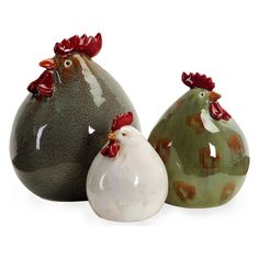 three ceramic roosters sitting next to each other