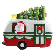 a christmas ornament with a santa clause on the front of a camper