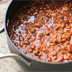 a pot filled with chili and beans on top of a table