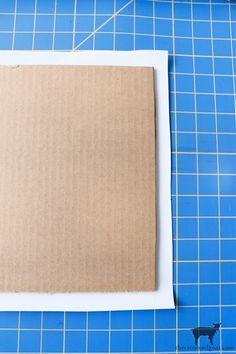 a piece of cardboard sitting on top of a cutting board