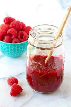 raspberry sauce in a mason jar with fresh raspberries