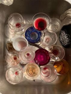 there are many wine glasses in the sink