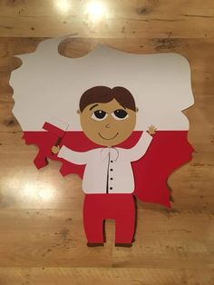 a paper cutout of a man holding a flag in front of a wooden floor