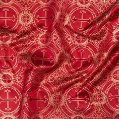 red and gold fabric with an intricate design on it's side, as well as the