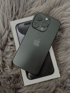 an iphone 11 pro is sitting on top of a box next to it's packaging