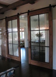 the inside of a house with sliding glass doors and wood flooring in front of it