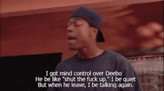 a man standing in front of a building with a quote on it that reads, i got mind control over debo he be like's shut the f