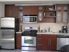 a kitchen with stainless steel appliances and wooden cabinets