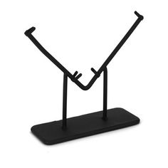 a black metal stand with two sticks sticking out of it's sides on a white background