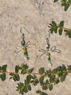 Handmade dragonfly wire earrings. These green beaded-wrapped earrings are an eyecatching staple to add to your earring collection. Fun by themselves and stack beautifully too! Handmade Green Dragonfly Jewelry, Green Wire Wrapped Beaded Earrings For Gift, Green Wire Wrapped Beaded Earrings As Gift, Green Adjustable Wire Wrapped Beaded Earrings, Wrapped Earrings, Earring Collection, Wire Earrings, Earrings Collection, Green Bead