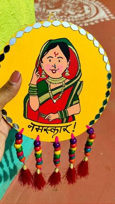 a person holding up a paper plate with an image of a woman in india on it