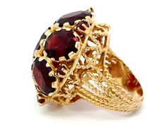 Ring Specifications:Metal: 14k Yellow GoldTotal Weight: 14.9 GramsGemstone: Red GarnetGarnet Carat Weight: ~21 caratsRing Size: 5.5 (resizable)Ring Measurements: 1" x 1"Stamped: "14K"Condition: Preowned, excellent100% Authentic. Please ask all questions before bidding or making a best offer. International Bidders please contact us before bidding for shipping availability and charges. Oval Multi-stone Ruby Ring For Formal Occasions, Heirloom Red Oval Cluster Ring, Red Oval Cabochon Ring For Formal Occasions, Formal Red Oval Cabochon Ring, Collectible Ruby Ring In Fine Jewelry Style, Collectible Fine Jewelry Ruby Ring, Red 14k Gold Cluster Ring, Oval Red Cluster Ring In 14k Gold, Red Hallmarked Cluster Ring