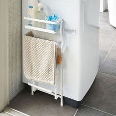 a white towel rack next to a washer and dryer