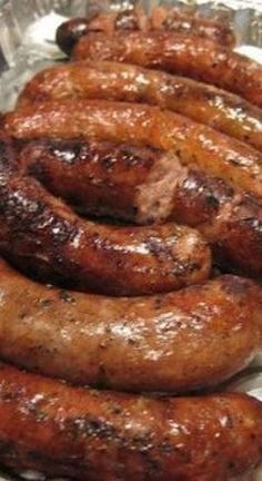 some sausages are in a metal pan on a table