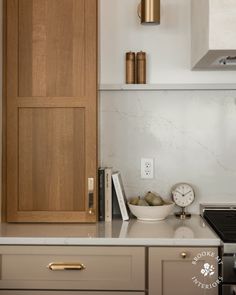 a kitchen with white counter tops and wooden cupboards next to a stove top oven