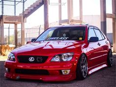 a red car parked in front of a building