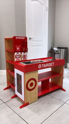 a red and white table with target products on it's shelves in front of a door