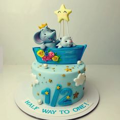 a birthday cake with an elephant and two elephants on top, all decorated in blue