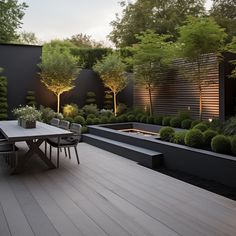 an outdoor dining area is lit up with lights and trees, along with benches and tables