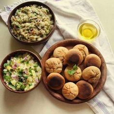 three bowls filled with food sitting on top of a table