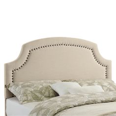 an upholstered headboard on a bed with pillows