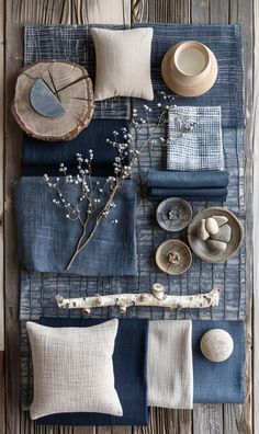 the table is set with blue linens, plates and other things to decorate it