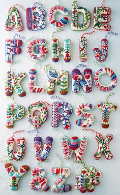 the letters are made up of different colors and shapes, including one that is decorated with candy canes