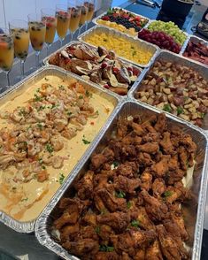 several trays filled with different types of food and drinks on top of a table