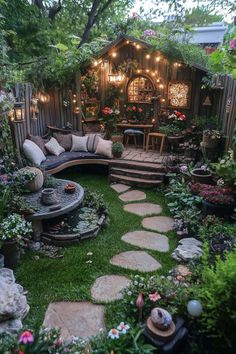 an outdoor garden with lots of plants and lights on the side of the house, surrounded by grass